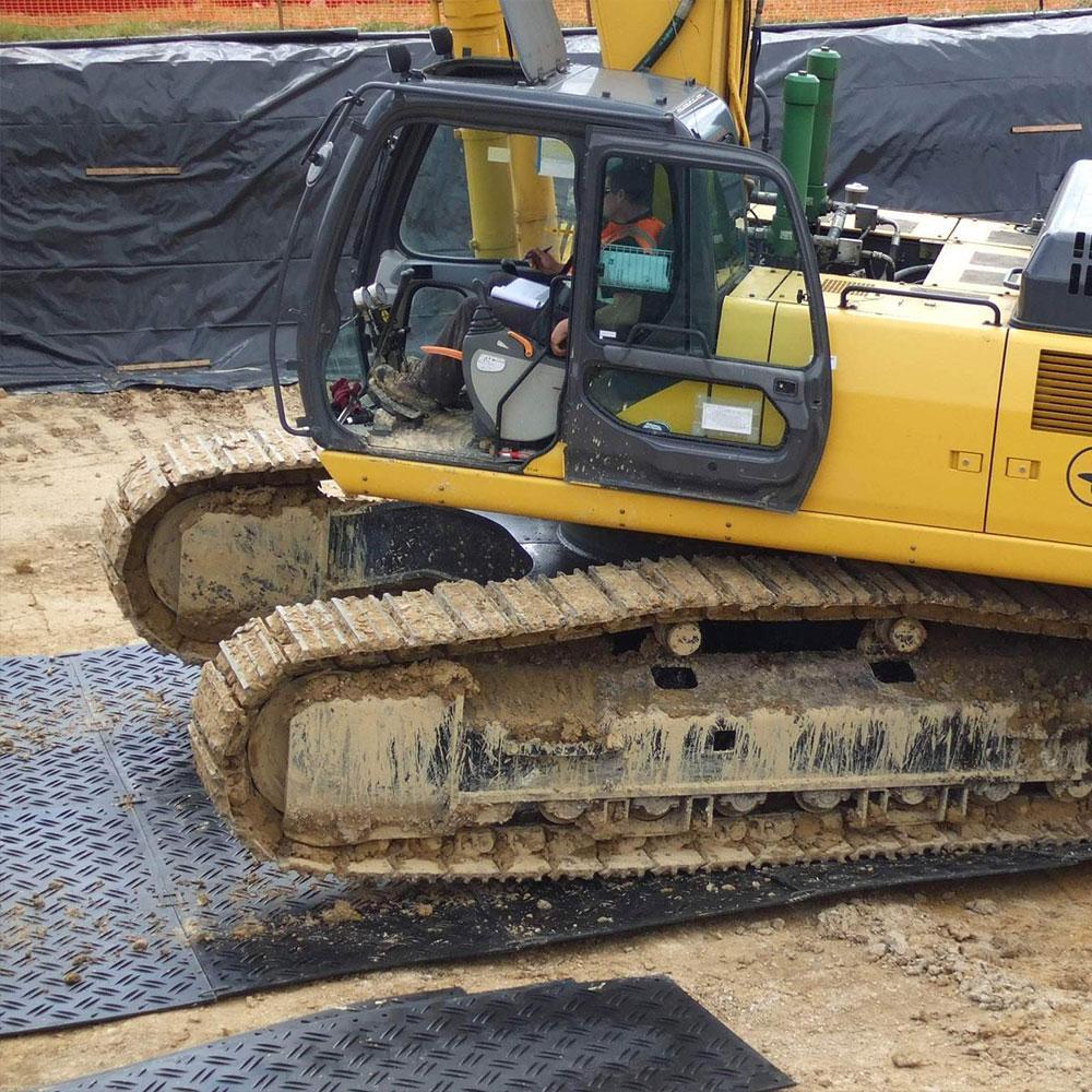 HDPE ground mats providing temporary access on a muddy construction site